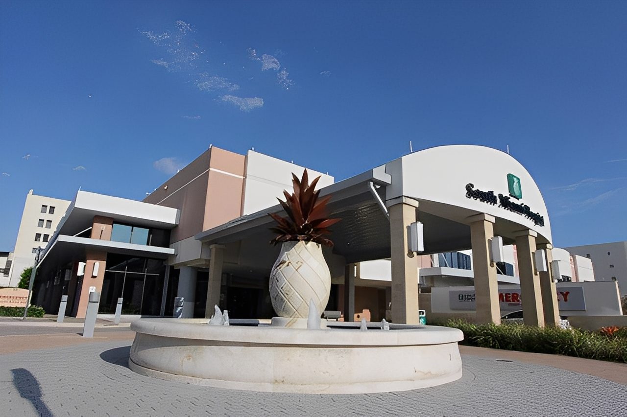 Modern building with fountain and clear sky.