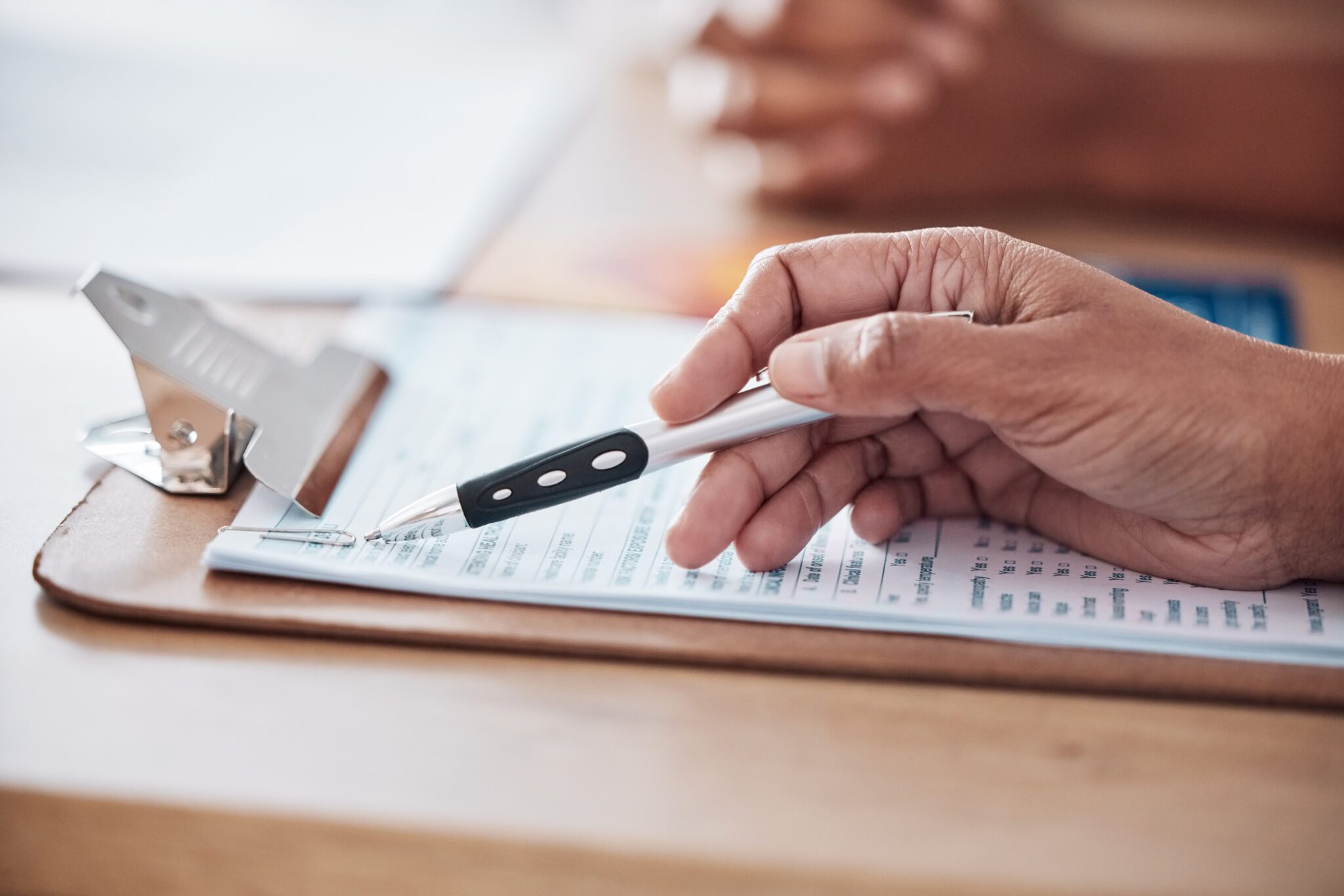 Hands, checklist or doctor consulting a patient in meeting in hospital for medical data or healthcare record history. Document closeup, paperwork or nurse with person speaking of test results or info