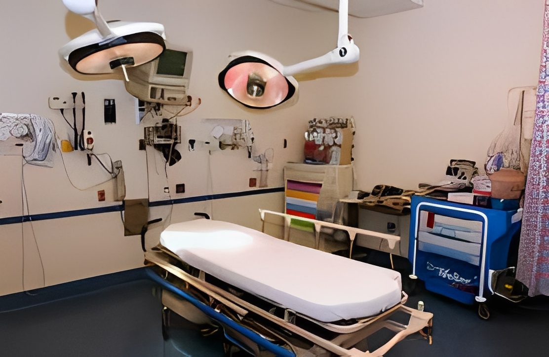 Hospital operating room with surgical equipment.